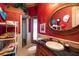 Elegant bathroom featuring bold red textured walls, granite counters and a walk-in shower at 841 Ponce De Leon Dr, St Petersburg, FL 33715