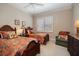Inviting bedroom with twin beds, shuttered windows, and dark wood furniture with chair at 841 Ponce De Leon Dr, St Petersburg, FL 33715