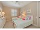 Cozy bedroom featuring twin beds, white furniture, and soft, colorful accents, creating a peaceful atmosphere at 841 Ponce De Leon Dr, St Petersburg, FL 33715