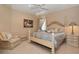Charming bedroom with a four-poster bed, soft linens, and elegant décor with neutral tones at 841 Ponce De Leon Dr, St Petersburg, FL 33715