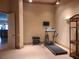 Well-lit exercise room features a treadmill, weights, TV, and carpeted floors, great for workouts at 841 Ponce De Leon Dr, St Petersburg, FL 33715