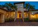 An elegant home featuring lush landscaping and an arched entryway at 841 Ponce De Leon Dr, St Petersburg, FL 33715