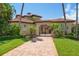 Mediterranean-style home featuring a tile roof, arched entryway, and brick driveway at 841 Ponce De Leon Dr, St Petersburg, FL 33715