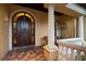 Welcoming arched wooden front door with sidelights, complemented by a cozy porch with stone accents at 841 Ponce De Leon Dr, St Petersburg, FL 33715