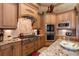 Gourmet kitchen boasts custom cabinets, granite countertops, stainless steel appliances, and designer tile backsplash at 841 Ponce De Leon Dr, St Petersburg, FL 33715