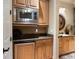 Convenient kitchenette offers a microwave, under-counter refrigerator, granite counters, and stylish fixtures at 841 Ponce De Leon Dr, St Petersburg, FL 33715