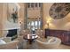Close up of the living room boasting a decorative fireplace, tall windows, and stylish seating at 841 Ponce De Leon Dr, St Petersburg, FL 33715