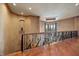 Elegant upstairs loft features hardwood floors, iron railing, and large windows, creating a luxurious ambiance at 841 Ponce De Leon Dr, St Petersburg, FL 33715