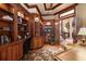 Stately home office features custom wood built-ins, beautiful floors and trim work, and a comfortable work space at 841 Ponce De Leon Dr, St Petersburg, FL 33715