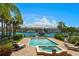 Stunning waterfront view with a private pool and hot tub area with palm trees and lounge chairs at 841 Ponce De Leon Dr, St Petersburg, FL 33715