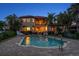 Stunning backyard with a pool, hot tub, patio, and lush tropical landscaping, all overlooking the serene waterfront at 841 Ponce De Leon Dr, St Petersburg, FL 33715