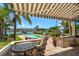 Outdoor living area with a covered patio, pool, and lush landscaping with marina views at 841 Ponce De Leon Dr, St Petersburg, FL 33715