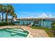Stunning waterfront pool and hot tub area with tropical landscaping overlooking the water at 841 Ponce De Leon Dr, St Petersburg, FL 33715