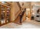 Elegant staircase featuring iron railings, a wooden banister and high ceilings at 841 Ponce De Leon Dr, St Petersburg, FL 33715