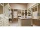Spacious walk-in closet with custom shelving, drawers, an island and ample storage at 841 Ponce De Leon Dr, St Petersburg, FL 33715