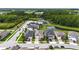 Overhead view of homes in the neighborhood and a pond with surrounding forest at 8460 Capstone Ranch Dr, New Port Richey, FL 34655