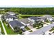 Aerial view of several homes in a neighborhood, a pond, and wooded areas at 8460 Capstone Ranch Dr, New Port Richey, FL 34655