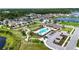 Gorgeous aerial view of community pool and playground, nestled among picturesque homes and landscaping at 8460 Capstone Ranch Dr, New Port Richey, FL 34655