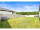 Spacious backyard with a well-manicured lawn, privacy fence, and mature trees at 8460 Capstone Ranch Dr, New Port Richey, FL 34655