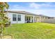 Large backyard with green lawn, covered patio and privacy fence at 8460 Capstone Ranch Dr, New Port Richey, FL 34655