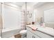 Well-lit bathroom featuring a tub with white subway tile surround, stylish fixtures, and vanity with countertop at 8460 Capstone Ranch Dr, New Port Richey, FL 34655