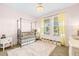 Charming Bedroom with a metal-frame crib, soft lighting, and ample storage at 8460 Capstone Ranch Dr, New Port Richey, FL 34655