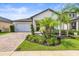 Charming one-story home features a two-car garage, brick driveway, and professionally landscaped yard at 8460 Capstone Ranch Dr, New Port Richey, FL 34655