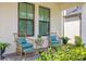 Inviting front porch with comfortable seating and lush landscaping at 8460 Capstone Ranch Dr, New Port Richey, FL 34655