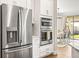 Modern kitchen with stainless steel appliances and dining area access at 8460 Capstone Ranch Dr, New Port Richey, FL 34655