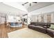 Open-concept living space features a modern kitchen, dining area, and a cozy living room with a large leather sofa at 8460 Capstone Ranch Dr, New Port Richey, FL 34655