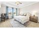 Tranquil main bedroom with a tray ceiling, plush bedding, and dedicated workspace at 8460 Capstone Ranch Dr, New Port Richey, FL 34655