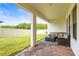 Covered outdoor patio featuring brick pavers and comfortable seating overlooking the backyard at 8460 Capstone Ranch Dr, New Port Richey, FL 34655