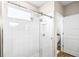 Shower featuring white subway tile surround, glass enclosure, and brushed nickel shower head at 8460 Capstone Ranch Dr, New Port Richey, FL 34655