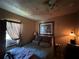 Modest bedroom with a comfortable bed and window AC unit at 8502 N Branch Ave, Tampa, FL 33604