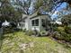 Charming cottage style home with mature trees and lush landscaping at 8502 N Branch Ave, Tampa, FL 33604