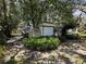 Exterior view of home showing the garage and surrounding yard with a large shade tree at 8502 N Branch Ave, Tampa, FL 33604