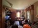 Vintage living room featuring a television, comfortable seating, and decorative accents at 8502 N Branch Ave, Tampa, FL 33604
