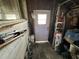 Storage area with a door leading outside, filled with equipment and tools, offering ample space at 8502 N Branch Ave, Tampa, FL 33604