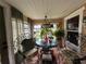 Bright sunroom filled with plants and decorative wrought iron seating, perfect for relaxation at 8502 N Branch Ave, Tampa, FL 33604