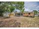 View of the backyard with covered patio and wooden fence at 9100 Lunar Ln, Port Richey, FL 34668