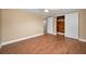 Spacious bedroom with hardwood floors, ceiling fan, and closet with sliding doors at 9100 Lunar Ln, Port Richey, FL 34668