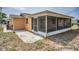 Exterior view of this home featuring a screened in porch and patio at 9100 Lunar Ln, Port Richey, FL 34668