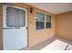 Charming front porch features a storm door and tiled flooring to welcome you home at 9100 Lunar Ln, Port Richey, FL 34668