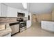 Updated kitchen featuring stainless steel appliances, white cabinets and an open concept design at 9100 Lunar Ln, Port Richey, FL 34668