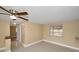 Bright living room with neutral walls, light tile floors, and ceiling fan at 9100 Lunar Ln, Port Richey, FL 34668