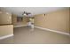 Bright living room with neutral walls, ceiling fan, and light tile floors, flowing into the dining area at 9100 Lunar Ln, Port Richey, FL 34668