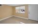 Bright living room with a large window, tile floors, and a neutral color scheme at 9100 Lunar Ln, Port Richey, FL 34668