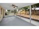Relax in this screened porch with view of fenced yard, pool and mature tree at 9100 Lunar Ln, Port Richey, FL 34668