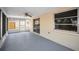 This is a screened in porch with a ceiling fan and views of the back yard at 9100 Lunar Ln, Port Richey, FL 34668