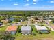 Aerial shot of the homes in a lushly landscaped community with a lake and preserve views at 9276 Ashley Dr, Weeki Wachee, FL 34613